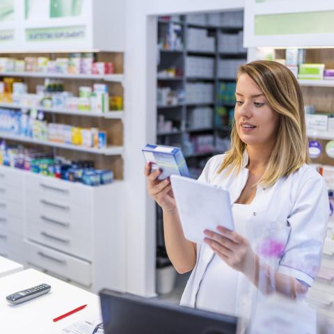 Pharmacist compares a medication to a prescription form